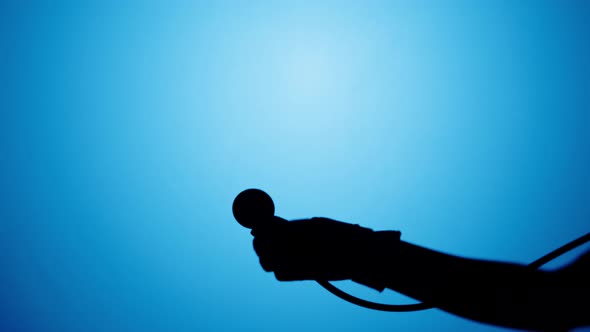 Shadow of Stethoscope on Blue Neon Background