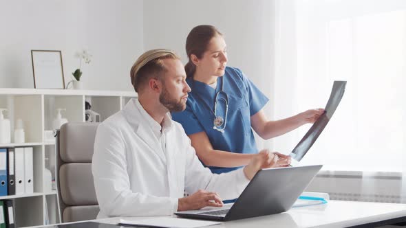 Professional medical doctors working in hospital office. Physician and the young nurse.