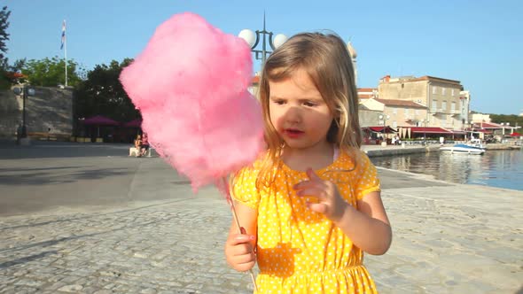 girl eating candy floss