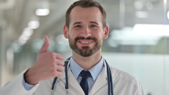 Portrait of Positive Male Doctor Showing Thumbs Up Sign 