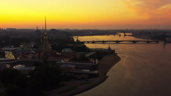 Drone Flight Over the Neva River to the Peter and Paul Fortress at Sunrise Reflection of the Orange