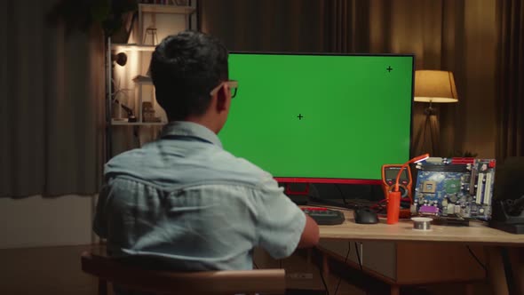 Engineer Asian Boy Is Working With Desktop Computer In Home, Mock Up Green Screen Display