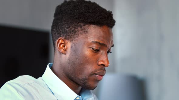 Young businessman typing on laptop keyboard