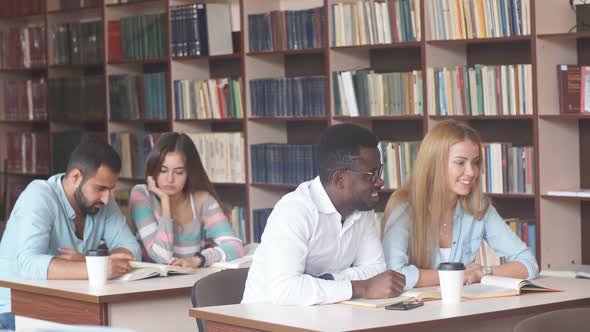 African American Male College Studen Preparing for Exams in the Library.