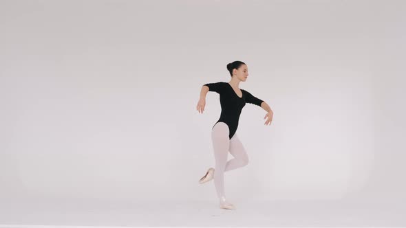 Woman Dancing Gracefully in Ballet Studio