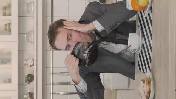 Businessman Drinking Out of Coffee Pot at Home