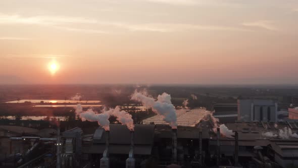 Aerial view Drone shot of flying around toxic chimneys tubing. Air Pollutants, Industrial zone