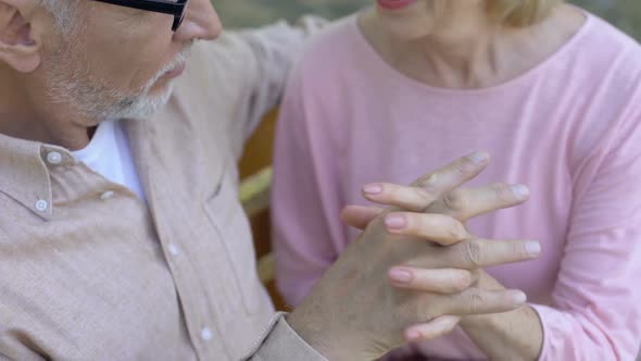 Romantic Retired Couple Crossing Fingers Holding Hands, Outdoor Date in Park