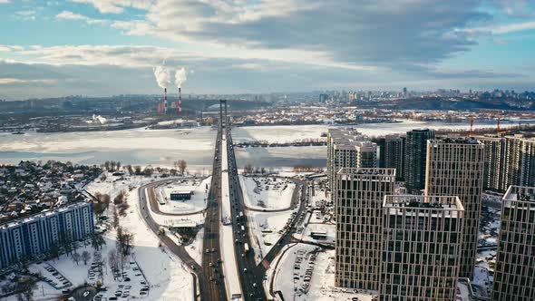 Aerial Quadcopter View of City Residential Buildings and Road with Cars Covered with Snow Tracking