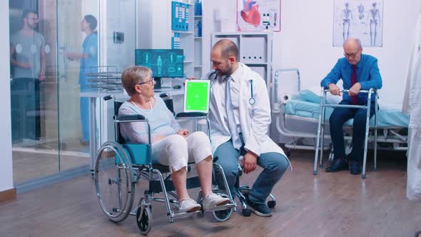 Doctor with Green Screen Tablet in Rehabilitation Center