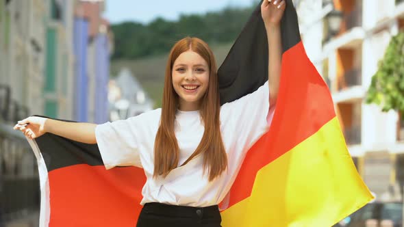 Cheerful Teenager Waving Flag of Germany and Smiling on Camera, National Holiday