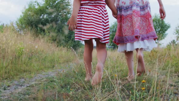 Two little girls walking on rural road