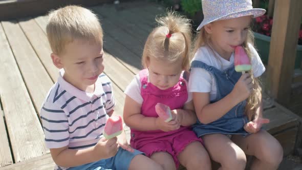 Three Cute Little Children Enjoys Delicious Ice Cream Cone