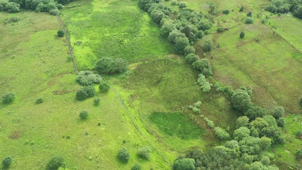 Aerial footage over green fields and English countryside