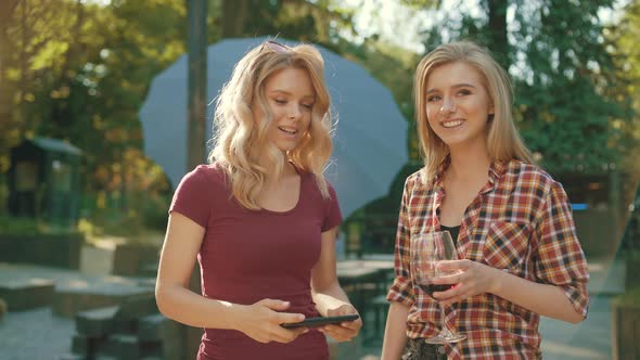 Happy Friends Taking Photos Outdoors. Girls Having Fun