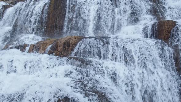 Cascading waterfall flowing over rocks in Granite Creek