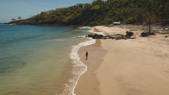 Girl Walking on the Beach