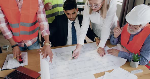 Team of Architects at the Head with Successful Bearded Main Architect Working Together