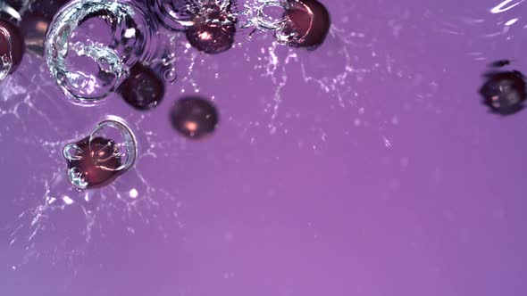 Grapes falling in water, Slow Motion