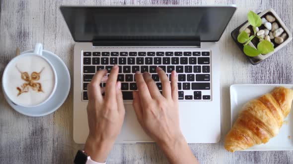 Top View Of Female Hands Typing On Laptop Keyboard On Coffee Break