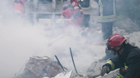 Male Rescuers Removing Concrete Rubble