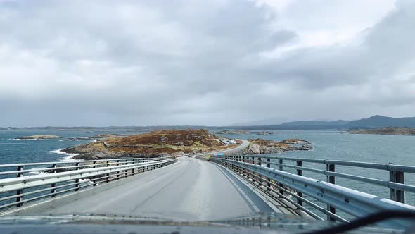Driving a Car on a Road in Norway Atlantic Ocean