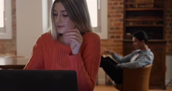 Caucasian woman concentrated and working in her house