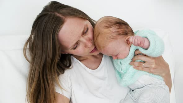 Focused Mom Soothing Baby Daughter