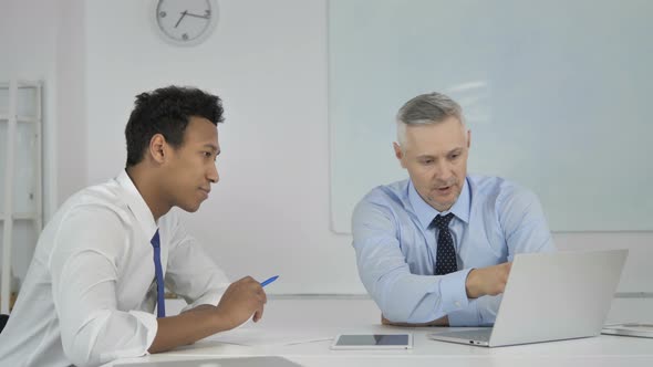 Senior Grey Hair Businessman Explaining Online Project on Laptop