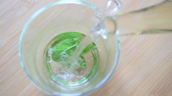 Pouring hot water into teaglass