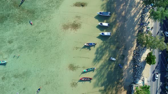 Amazing aerial Top view Longtail fishing boats in the tropical sea at Rawai beach Phuket Thailand