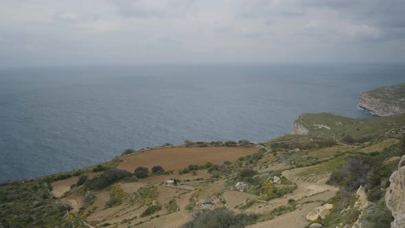 Scenic panorama of a typical mediterranean landscape on the island of Malta with the sea merging wit