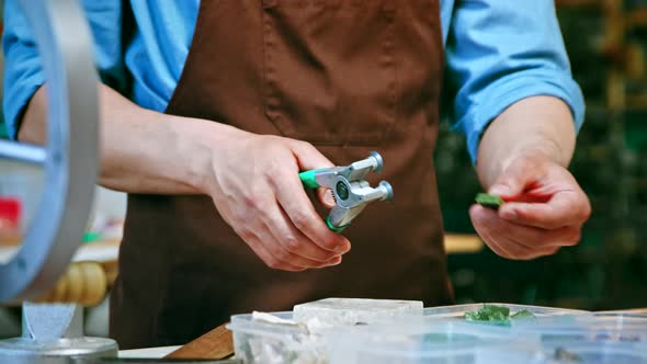 Male hands cutting a piece of stone