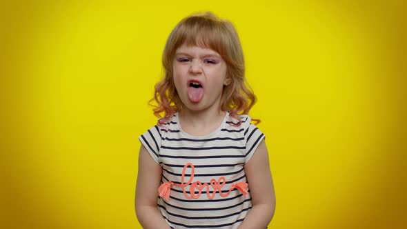 Child Girl Showing Tongue Making Faces at Camera Fooling Around Joking Aping with Silly Face Teasing