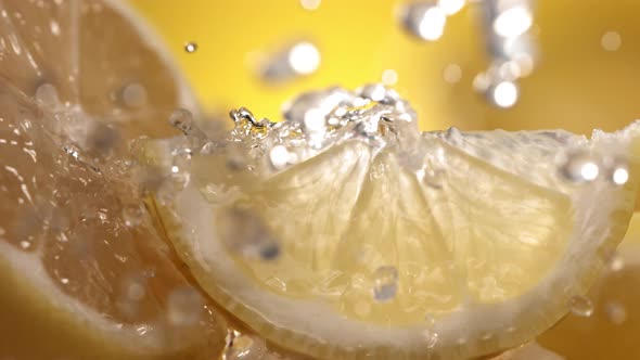 Slow Motion Shot of Lemon and Water Splashing Through Lemon Slices