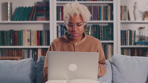 African Woman with Headset Enjoying Conversation By Video Call Sharing Knowledge