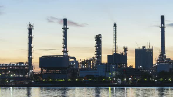 4k timelapse of 4k Oil refinery  petrochemical plant timelapse at sunrise with reflection of river