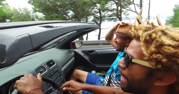 Black handsome men enjoying driving his friends in convertible