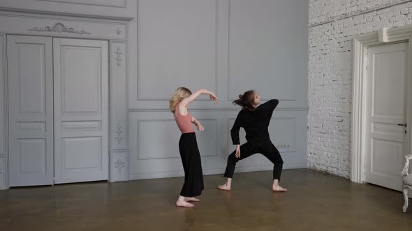 Couple of Two Dancers is Rehearsing Contemporary Choreography in Dance Studio