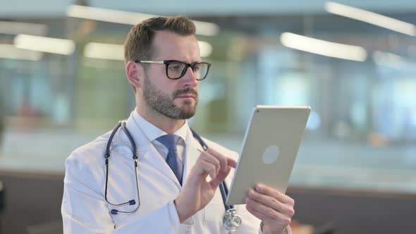 Portrait of Young Male Doctor Using Digital Tablet