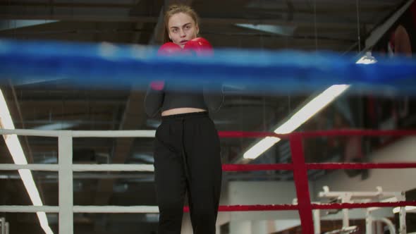 A Young Woman with Long Hair About To Train Her Shadow Boxing