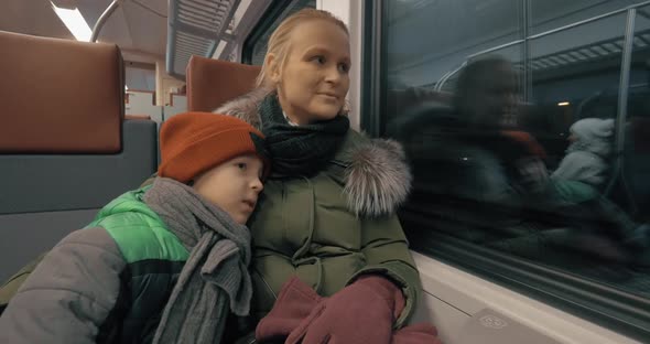 Mother and Her Gentle Loving Son Traveling By Train