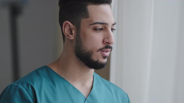 Young Pensive Hispanic Doctor Male Thoughtful Arabian Nurse Practitioner Therapist Surgeon Stand