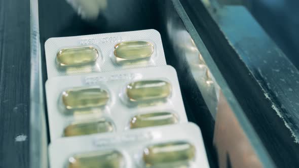 Blisters with Capsules Going on a Conveyor