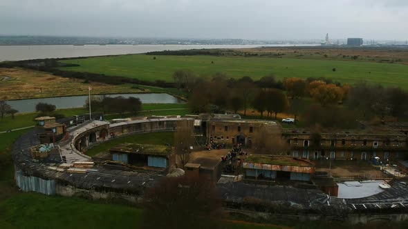 Flying away from the historic Coalhouse Fort in Essex, England. East Tilbury. River Thames in backgr