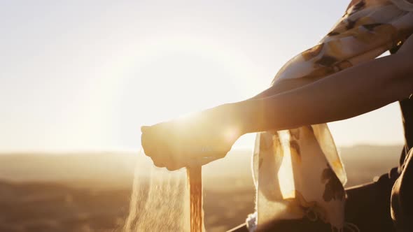 Woman'S Hands Holding And Letting Go Of Desert Sand