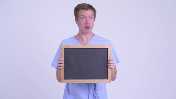 Crazy Young Man Patient Holding Blackboard