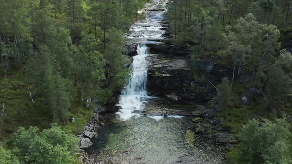 Small cozy hidden waterfall in middle of long river in hidden norwegian woods - Clean bright sparkli