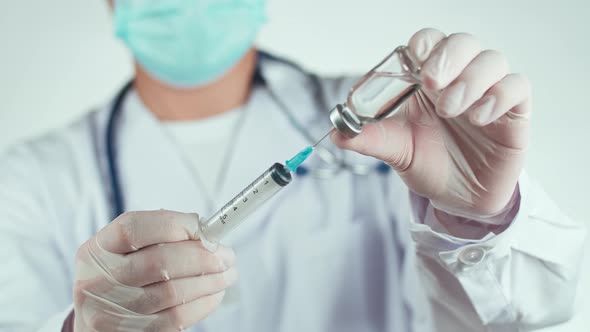 Doctor Hand Holding A Syringe With Liquid Vaccines