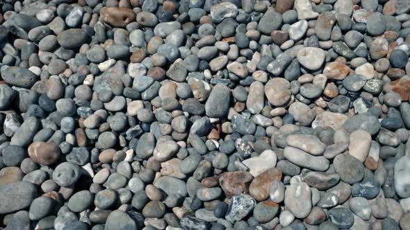 Moving Over Countless Beach Pebbles